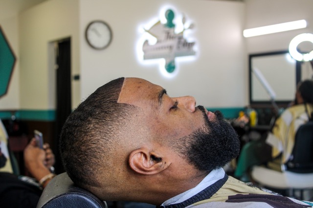 bald fade haircut in barbershop.